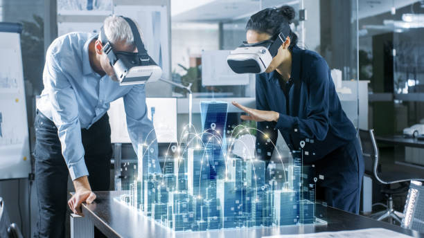 male and female architects wearing  augmented reality headsets work with 3d city model. high tech office professional people use virtual reality modeling software application. - simulator imagens e fotografias de stock