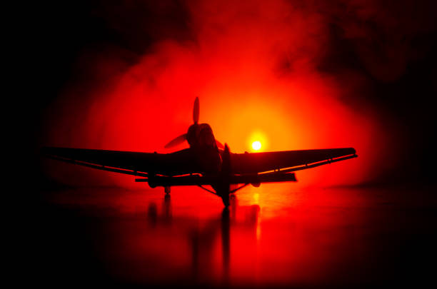 istock German Junker (Ju-87) jet-propelled model plane in possession. Dark orange fire background. War scene. Selective focus (Difference position placement) 921020060