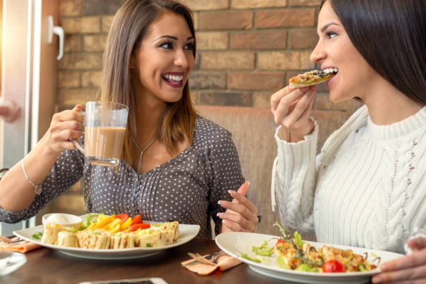 istock Two girlfriends having lunch together at a restaurant 921022496