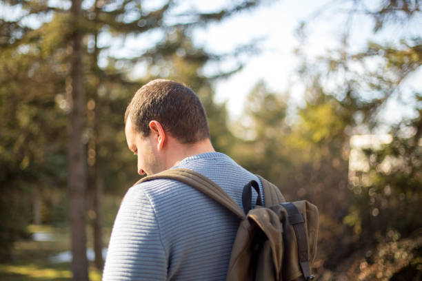 istock Man backpacker trying to find their way. man backpacker in forest 921022730