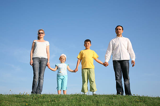 istock family of four on grass 92102358