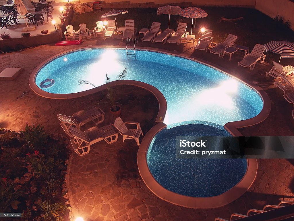 Swimming pool by night Hotel swimming pool illuminated at night Blue Stock Photo