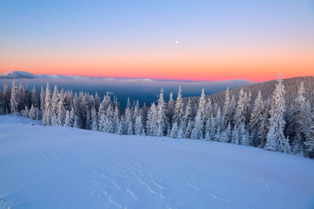 istock Landscape with high mountains covered with snow. Interesting frozen texture. Beautiful winter sunrise with orange blue sky. Place for tourists. Christmas story. 921026144
