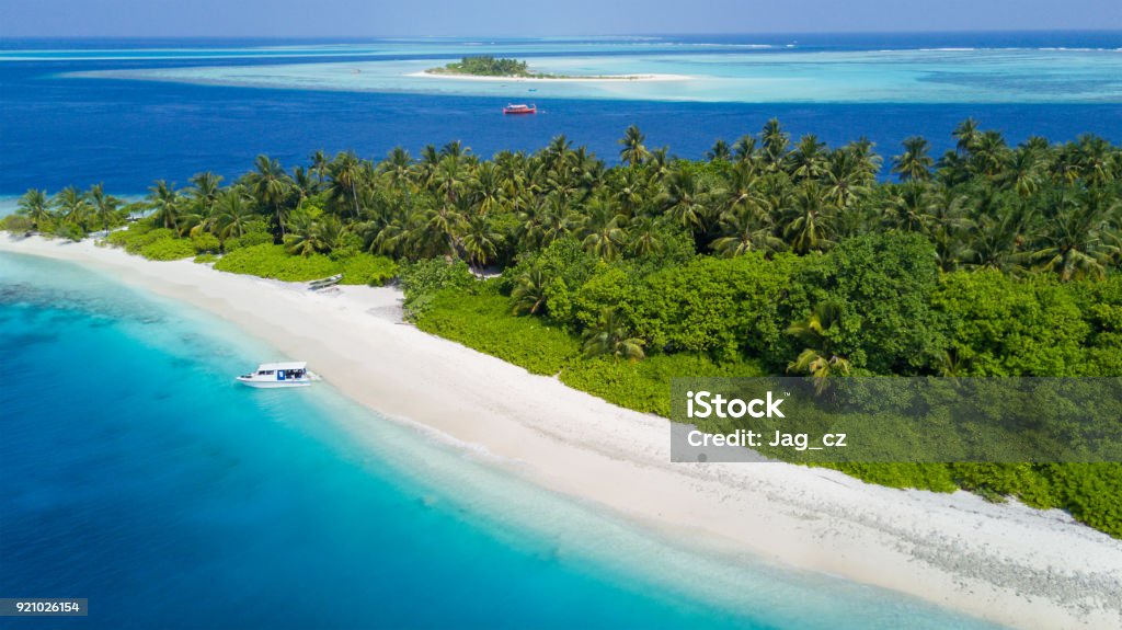 Aerial view of tropical iceland with sandy beach, Maldives Aerial view of tropical iceland with sandy beach, Maldives. Exotic holiday in Indian ocean Aerial View Stock Photo
