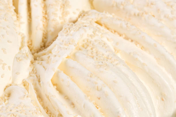 istock Vanilla ice-cream detailed macro texture with nuts 921029602