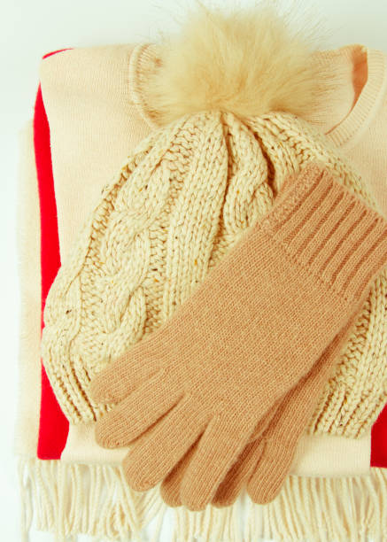 istock Warm winter knitted clothes - hat, scarf, gloves on a white background. 921032242
