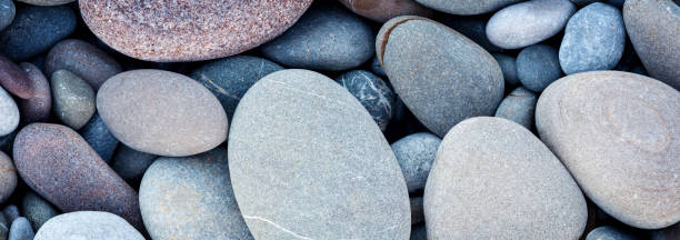 istock Web banner abstract smooth round pebbles sea texture background 921035424