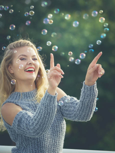 istock Joyful teen woman blowing bubbles 921035534