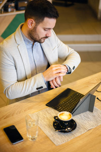 istock Busy young businessman looking at his watch. 921036280