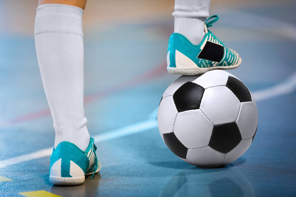 giocatore sportivo di calcio indoor con palla. giocatore di calcio a 5, palla, pavimento futsal. background sportivo. campionato giovanile di calcio a 5. giocatori di calcio indoor con calcio classico. - futsal indoors soccer ball soccer foto e immagini stock