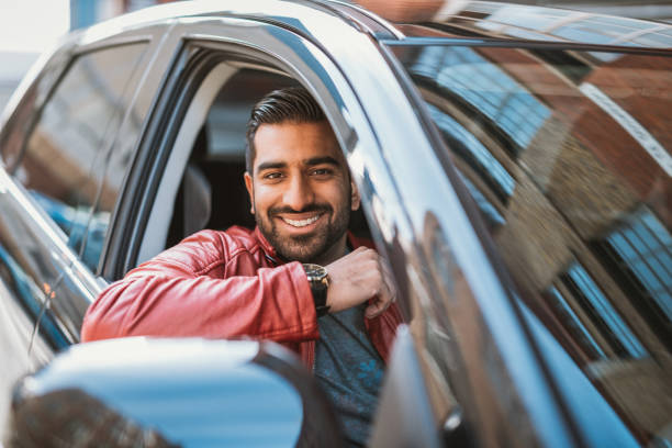 istock Indian man driving luxury taxi 921039506