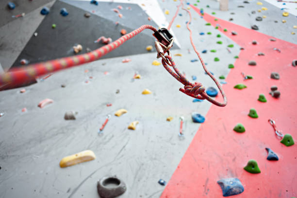 istock Climbing. A safety bolt threaded a rope with a carbine. Granite wall 921039688