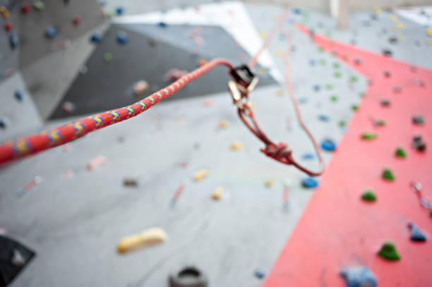 istock Climbing. A safety bolt threaded a rope with a carbine. Granite wall 921039700