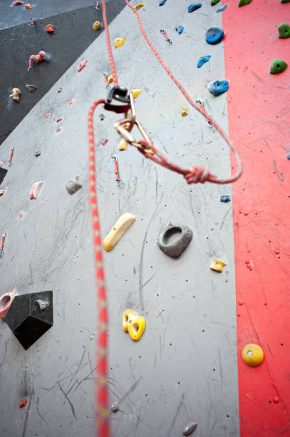 istock Climbing. A safety bolt threaded a rope with a carbine. Granite wall 921039762