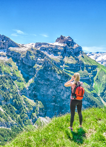 traveler screams against the backdrop of the mountain peaks, the Engelberg resort, Switzerland