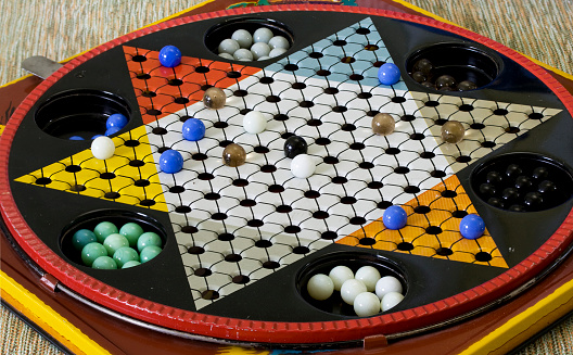 Handmade soapstone tic tac toe board game with white crochet tablecloth. Brazilian handicraft. Selective focus