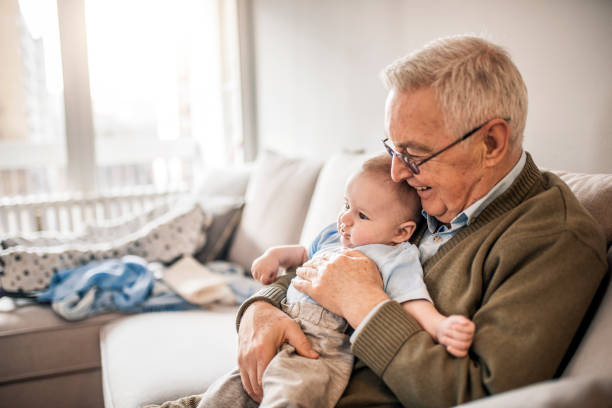 istock Holding His Newborn Grandson 921042462