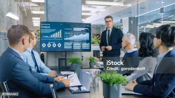 Young Stock Trader Shows To The Executive Managers Cryptocurrency And Trade Market Correlation Pointing At The Wall Tv Stock Photo - Download Image Now