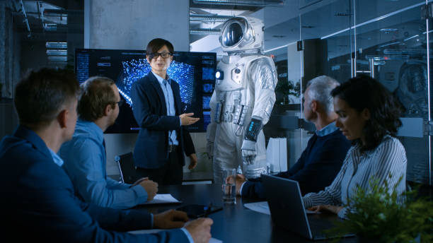 istock In the Conference Room Chief Engineer Presents Next Generation Space Suit to a Board of Directors. Completely Original Design with Integrated AI and Neural Network Systems. New Level of Space Travel. 921054656