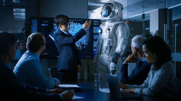 in the conference room of the center of technology chief engineer presents next generation space suit to a board of directors. completely original design with integrated ai and neural network systems. - smiling research science and technology clothing imagens e fotografias de stock