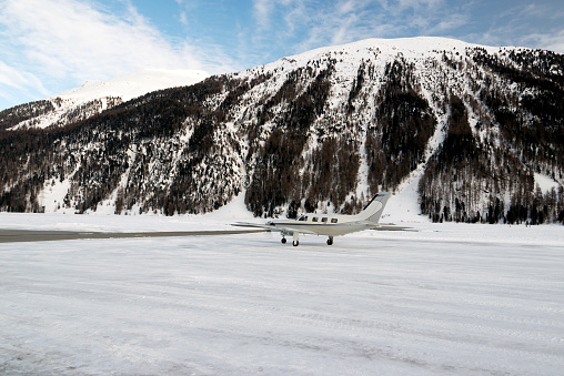 A private jet is ready to take off in the airport of St Moritz Switzerland in winter