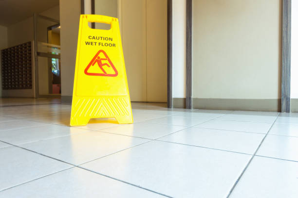 istock Cleaning and caution wet flooring signboard on the floor 921057946