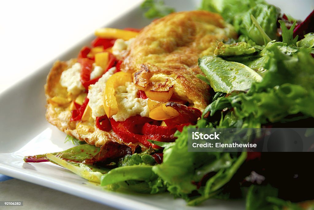 Close up of delicious omelets served with fresh greens Freshly made omelette served with green salad Breakfast Stock Photo