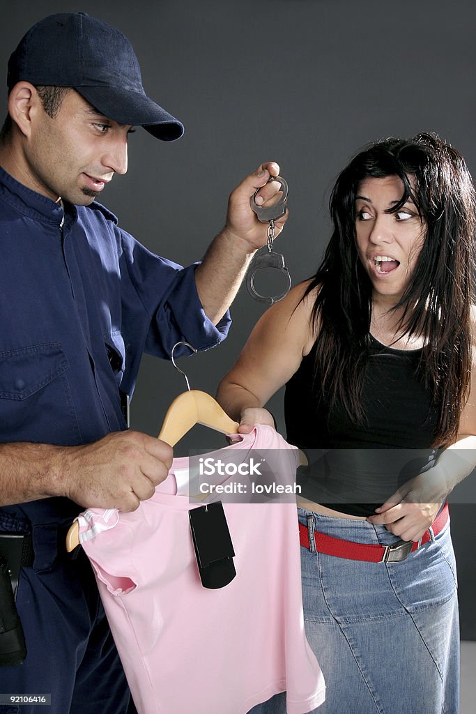 Shoplifting is a crime Shoplifting is a crime.  A security guard dangles handcuffs at a shoplifter.  Retailers lose $25 million a day to shoplifting. Security Guard Stock Photo