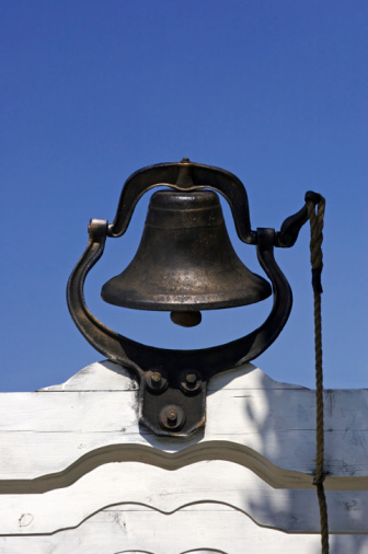 A view of bells on tower of white church building