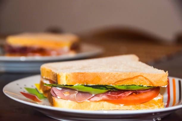 istock sandwich with prosciutto tomato and green salad on  bright plate 921065330
