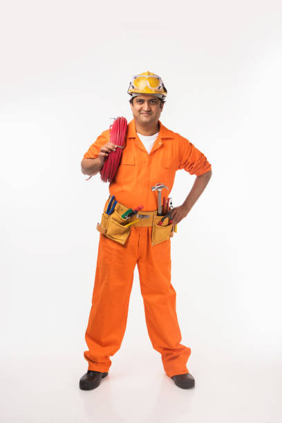 istock Indian electrician engineer in action with wire cutter, standing isolated over white background 921077492