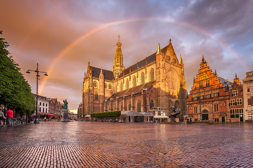 Breathtaking sunset dark clouds and orange Grote Kerk in Haarlem city center, North Holland, The Netherlands