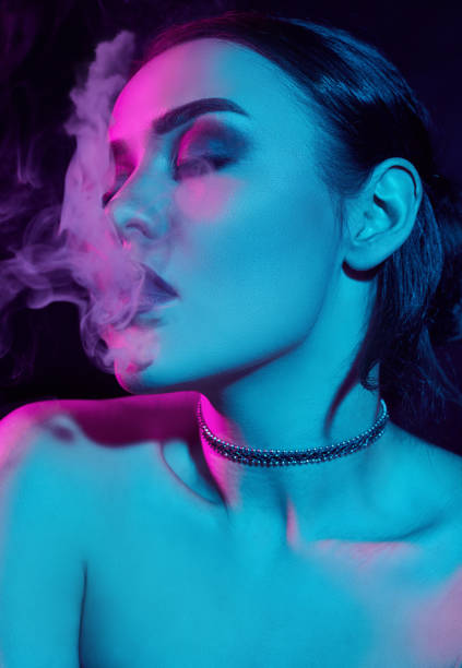 istock Glamour seductive gorgeous brunette woman smoking electronic cigarette 921080512