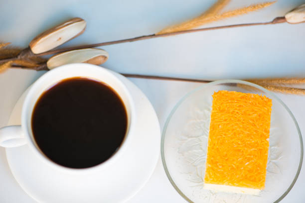 istock A cup of coffee and golden threads cake 921080790