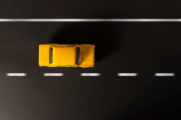 istock Yellow toy car on a black background. 921081384