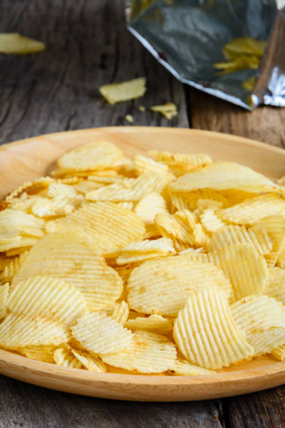 istock Snacks in a wooden dish on a table 921081624