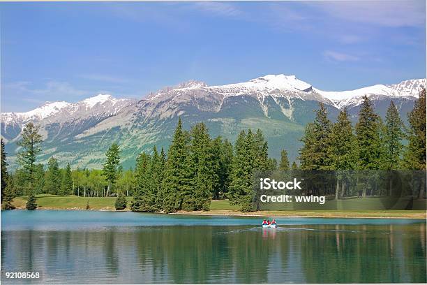 Boaters On Mountain Lake With Dramatic Surroundings Stock Photo - Download Image Now