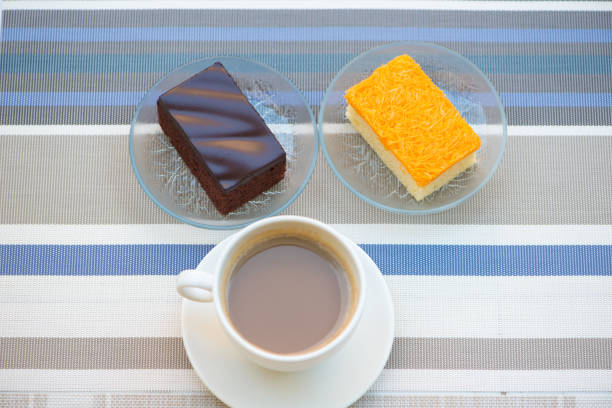 A cup of coffee and bakery cake show food and beverages concept