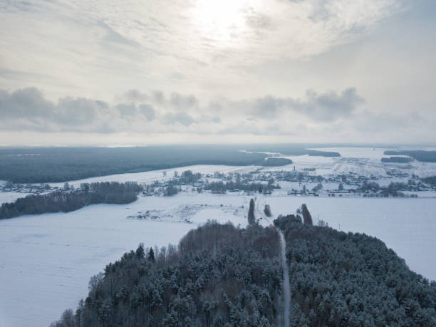 istock Winter rural aerial view. Landscape with fields, village, forest and meadow 921089268