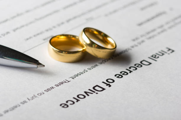 istock Divorce decree form with marriage ring and pen 921089484