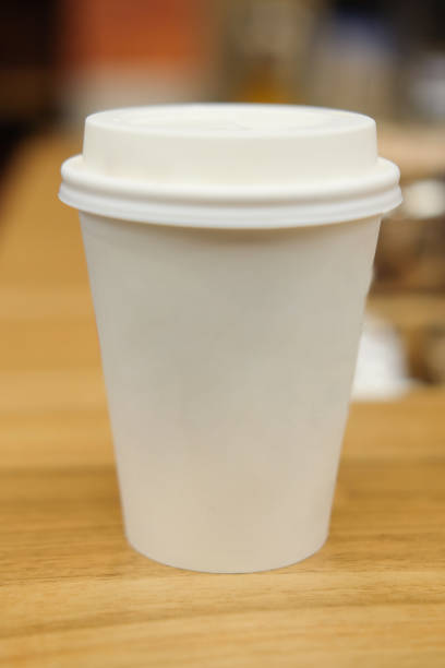 istock Take away disposable coffee cup on wooden table 921092118