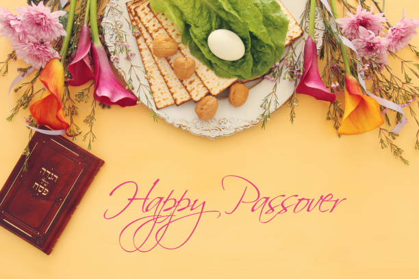 istock Pesah celebration concept (jewish Passover holiday). Traditional book with text in hebrew: Passover Haggadah (Passover Tale). 921092156