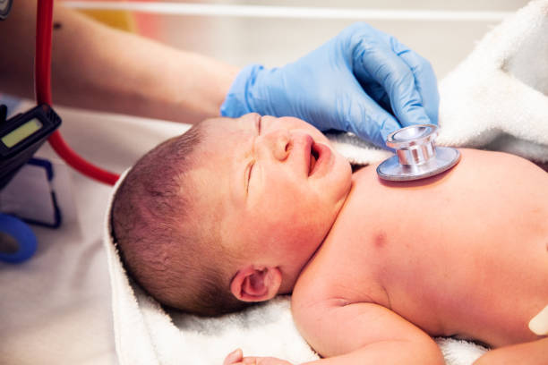 Newborn baby checked with a stethoscope stock photo