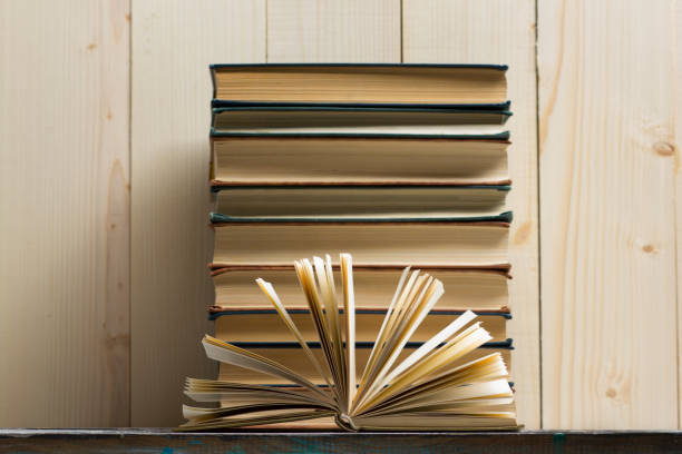 istock Open book, hardback books on wooden table. Back to school. Copy space 921093118