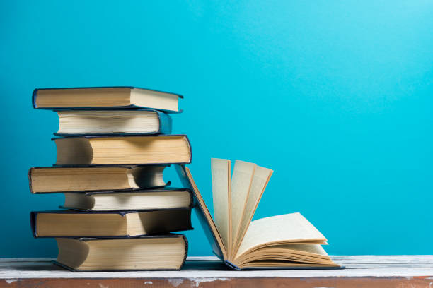 istock Open book, hardback books on wooden table. Back to school. Copy space 921095852