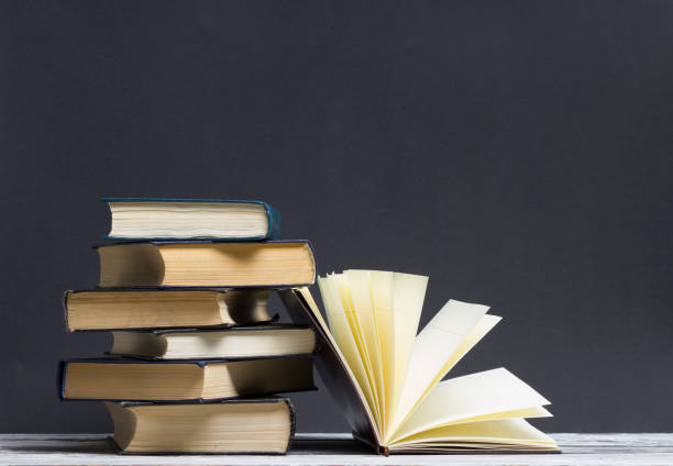 istock Open book, hardback books on wooden table. Back to school. Copy space 921095870