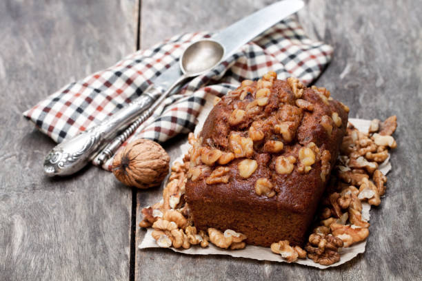 istock Homemade  date and walnut loaf cake on old wooden table 921096024