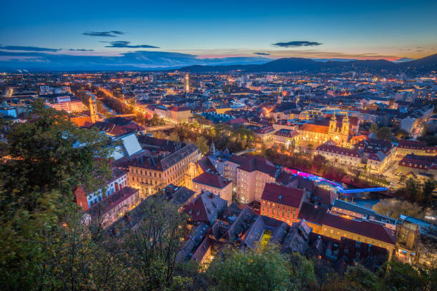 aerial view of the city of graz at night, styria, austria - graz austria clock tower styria imagens e fotografias de stock