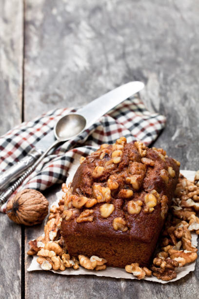 istock Homemade  date and walnut loaf cake on old wooden table 921101424