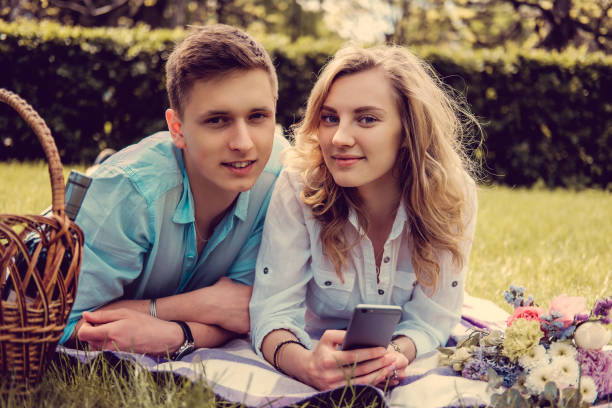 istock Casual young couple relaxing on a lawn. 921104652